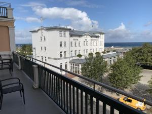 a view of a white building from a balcony at Berringer, Backbord, direkt an der Promenade in Warnemünde