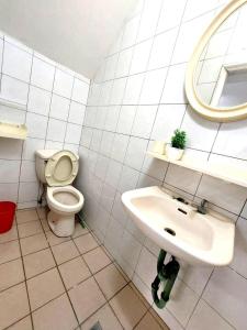 a white bathroom with a toilet and a sink at 南科驛站 in Xinshi