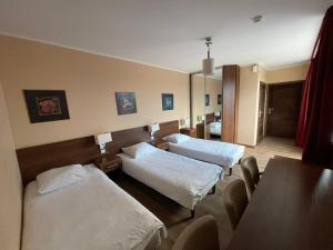 a hospital room with two beds and a table at Motel Pieprzyk in Kołobrzeg