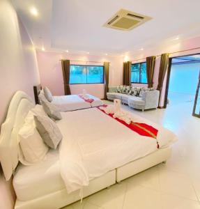 Un dormitorio con dos camas y una sala de estar. en Sunny2 Villa Pattaya, en Ban Huai Yai