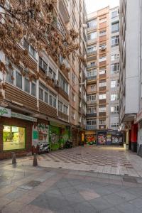 an empty street in a city with tall buildings at tuGuest Pedro Antonio Apartment in Granada