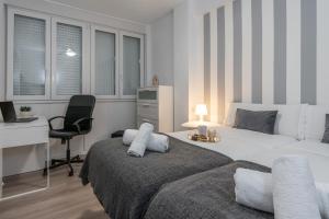 a bedroom with a bed and a desk and a chair at tuGuest Pedro Antonio Apartment in Granada