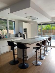 a kitchen with a large table and some chairs at La villa Garonne avec piscine in Toulouse