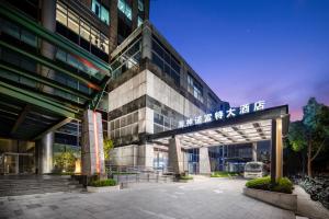 a building with a sign on the side of it at Novotel Atlantis Shanghai - Enjoy our great-valued breakfast in our rooftop revolving restaurant with a stunning river view & utilize our FREE self-serviced laundry in Shanghai