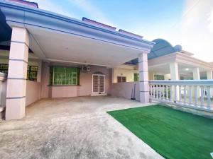 a house with a green lawn in front of it at Kim_Homestay in Tawau