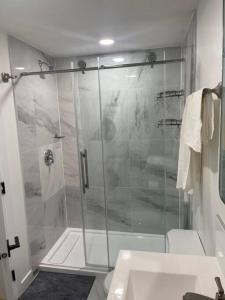 a bathroom with a shower with a glass door at Stylish 2 Bedroom suite in SW Edmonton close to Windermere and Edmonton International Airport in Edmonton