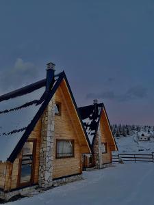 a log cabin with snow on the roof at Portes du Soleil - Zabljak in Žabljak
