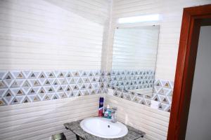 a bathroom with a sink and a mirror at Nziza View Hotel in Kigali