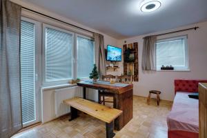 a room with a desk and a bed and windows at Apartment Hanny in Laško