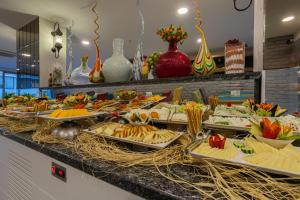 a buffet with many plates of food on a counter at Best Western Plus Khan Hotel in Antalya