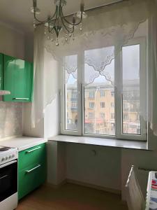 a kitchen with green cabinets and a window at VERY central location near State department store in Ulaanbaatar