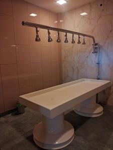 a large white sink in a bathroom with lights at Nirvana Club Resort and Spa in Bangalore