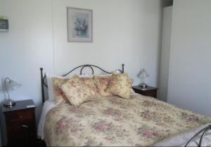 a bedroom with a bed with a floral bedspread at Lavendale Country Retreat in York