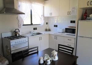a kitchen with a table and a stove and a refrigerator at Lavendale Country Retreat in York