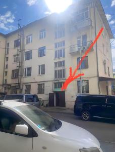 a white car parked in front of a building at VERY central location near State department store in Ulaanbaatar