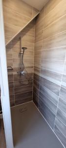 a bathroom with a shower with wooden walls at Aux Passagers de la Baie 3 in Le Crotoy +39 photos