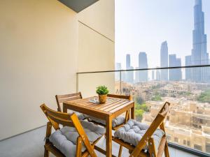 a dining room with a table and chairs and a large window at Lavishly Elegant 2BR with Breathtaking Full Burj Khalifa View in Dubai