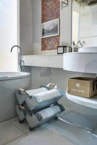 a bathroom with a toilet and a sink and a mirror at JW Marriott Hotel Hangzhou in Hangzhou