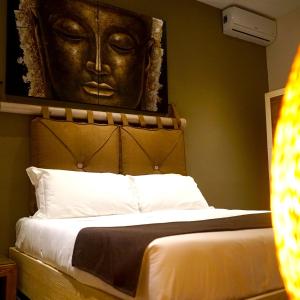 Un pat sau paturi într-o cameră la Mini Hotel - Angolo Di Paradiso -