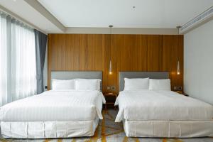 Katil atau katil-katil dalam bilik di Home Hotel