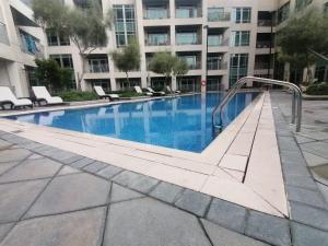 a swimming pool in a building with chairs and a building at Burj Views Tower c, Downtown,Dubai UAE in Dubai