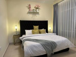 a bedroom with a large bed with white sheets and pillows at Burj Views Tower c, Downtown,Dubai UAE in Dubai