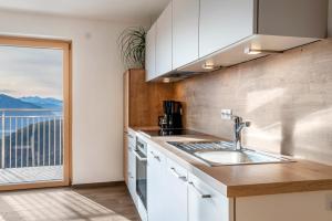 a kitchen with a sink and a window with a view at Reiterhof Apt Gaia in San Genesio Atesino