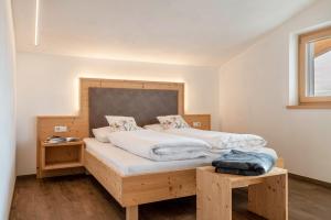 a bedroom with two twin beds with a wooden headboard at Reiterhof Apt Gaia in San Genesio Atesino