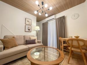 a living room with a couch and a table at GIVE Kagurazaka in Tokyo