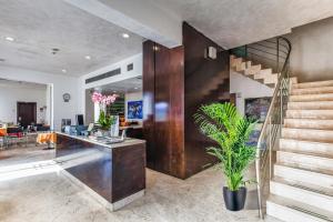 a living room with a staircase and a lobby at Hotel Trieste in Mestre