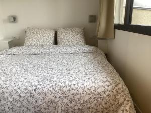 1 dormitorio con 1 cama con edredón de flores en Paris centre en 15mn *3, en Nogent-sur-Marne