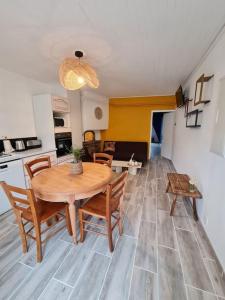 a kitchen and dining room with a table and chairs at Gite du bibicherat in Largillay-Marsonnay