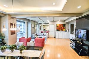 a living room with a couch and a table at Avant Spacious Sanctuary with the best view in BGC in Manila