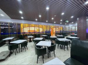 a dining room with tables and chairs in a restaurant at President Hotel Shenzhen - Yitian Metro Station in Shenzhen