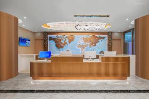 an office with a map of the world on the wall at President Hotel Shenzhen - Yitian Metro Station in Shenzhen