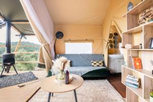 a living room with a couch in a tent at Civara Chalet - Private Glamping in nature with Jakuzzi in Tsivarás