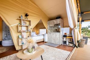 a living room with a tent with a table at Civara Chalet - Private Glamping in nature with Jakuzzi in Tsivarás