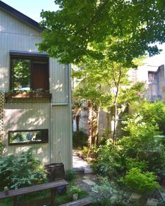 a garden with a bench next to a building at Hakone Mori No Yado in Hakone