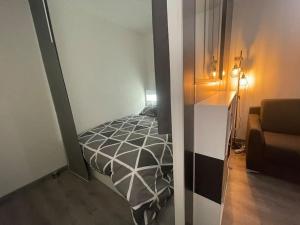 a small bedroom with a bed and a couch at Le Cocon Hyèrois in Hyères
