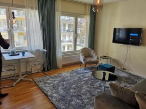 a living room with a couch and a table at Norrköping City in Norrköping