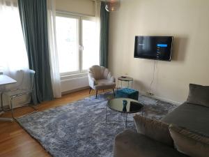 a living room with a couch and a tv at Norrköping City in Norrköping