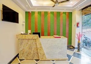 an office with a reception desk and a television at Hotel Indiana Palace in Kānpur