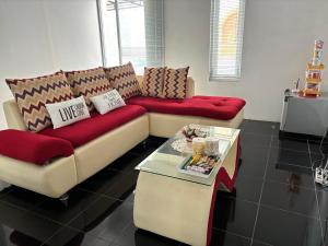 a living room with a couch and a coffee table at Adrian Family Homestay in Yogyakarta