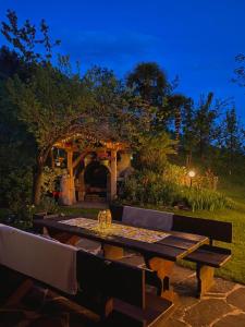 a picnic table in front of a gazebo at night at Pension St. Ursula in Saltusio