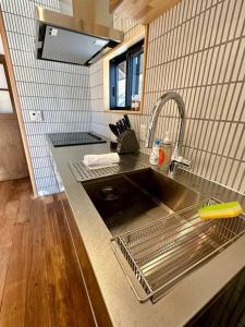 a kitchen with a sink and a counter top at The Misorano Cottage in Hakuba