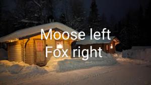 a house lit up in the snow at night at Lapland Snow Moose in Vittangi Kapell