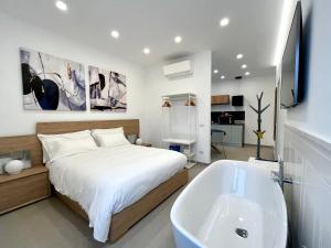 a bedroom with a bed and a tub and a sink at TRASTEVERE URBAN SUITE in Rome