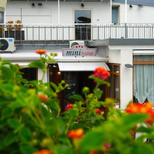 a small hotel sign on the side of a building at Mini Hotel - Angolo Di Paradiso - in Pozzuoli