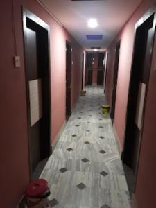 a long hallway with ailed floor in a building at Hotel Monsoon , Shillong in Shillong