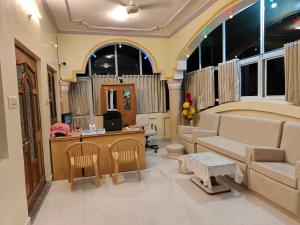 a living room with a couch and a table at Light House Homestay in Mount Ābu